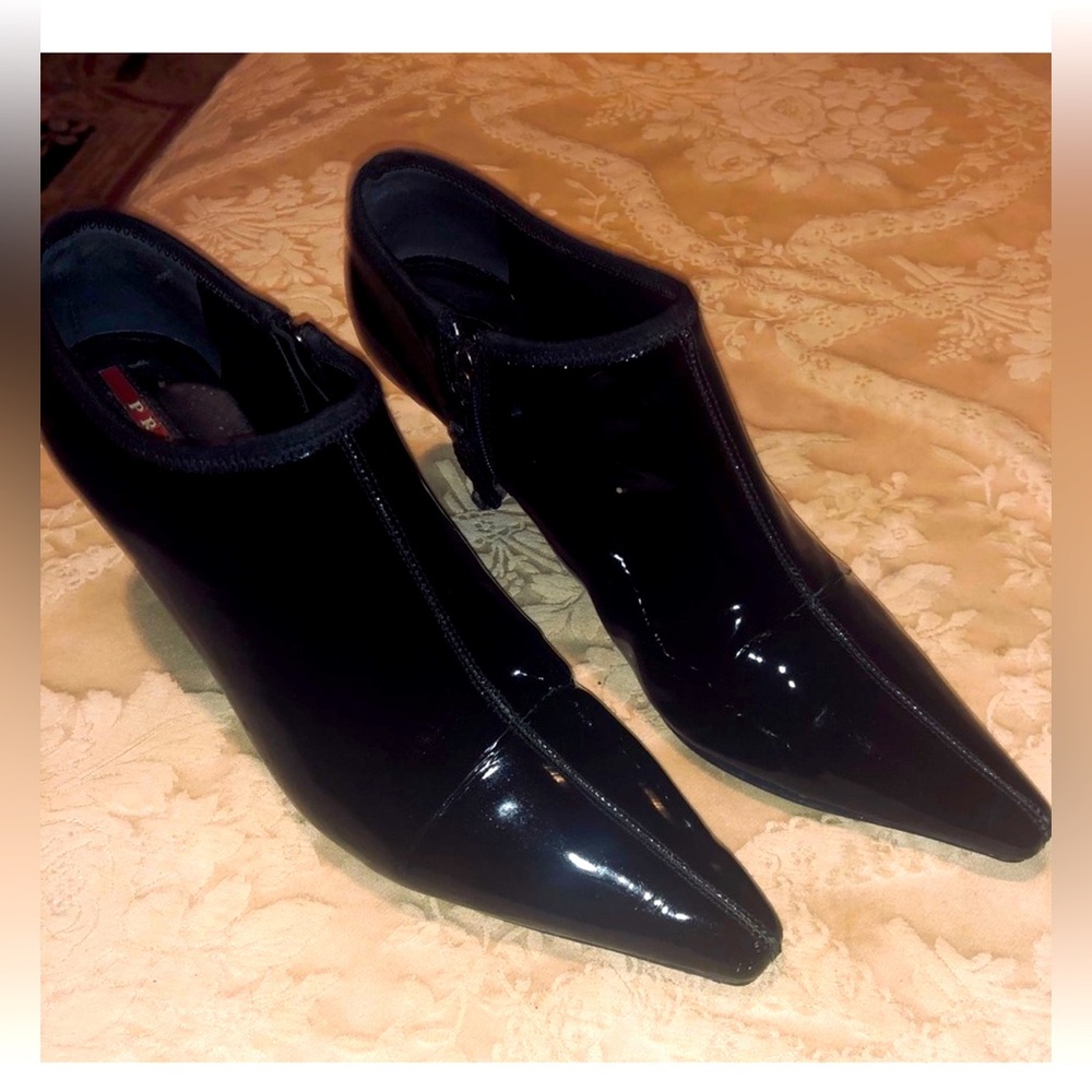 Prada black patent leather ankle boots. Heals repaired.
They are small for me.
